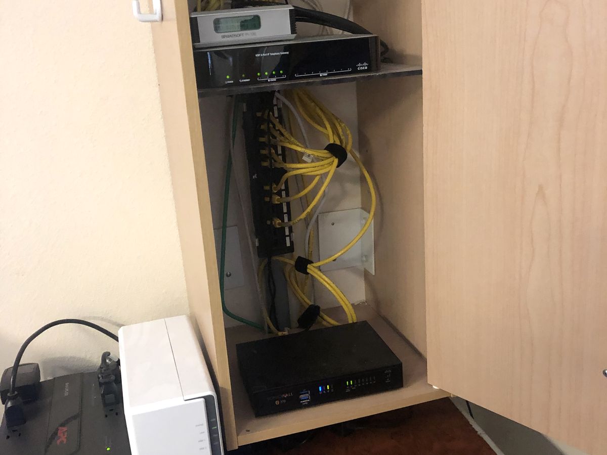 Organized small-office network cabinet with firewall, patch panel, NAS and UPS