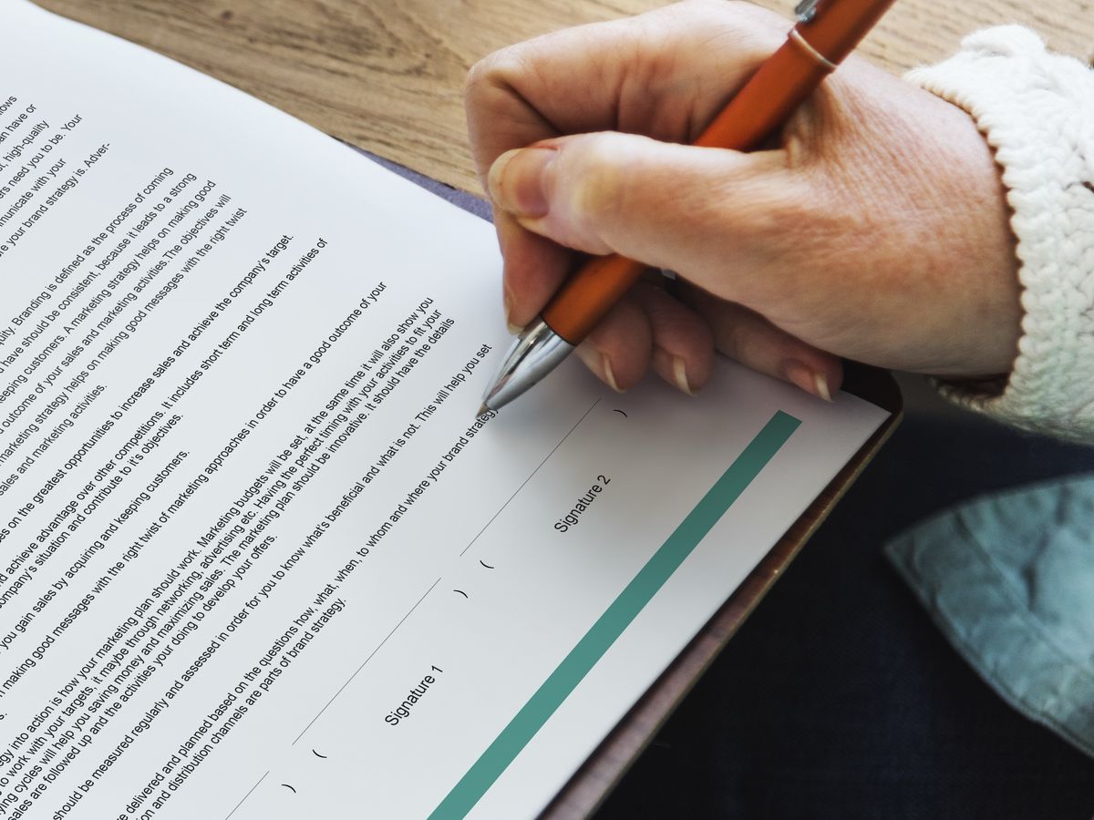 Signing an agreement at a desk