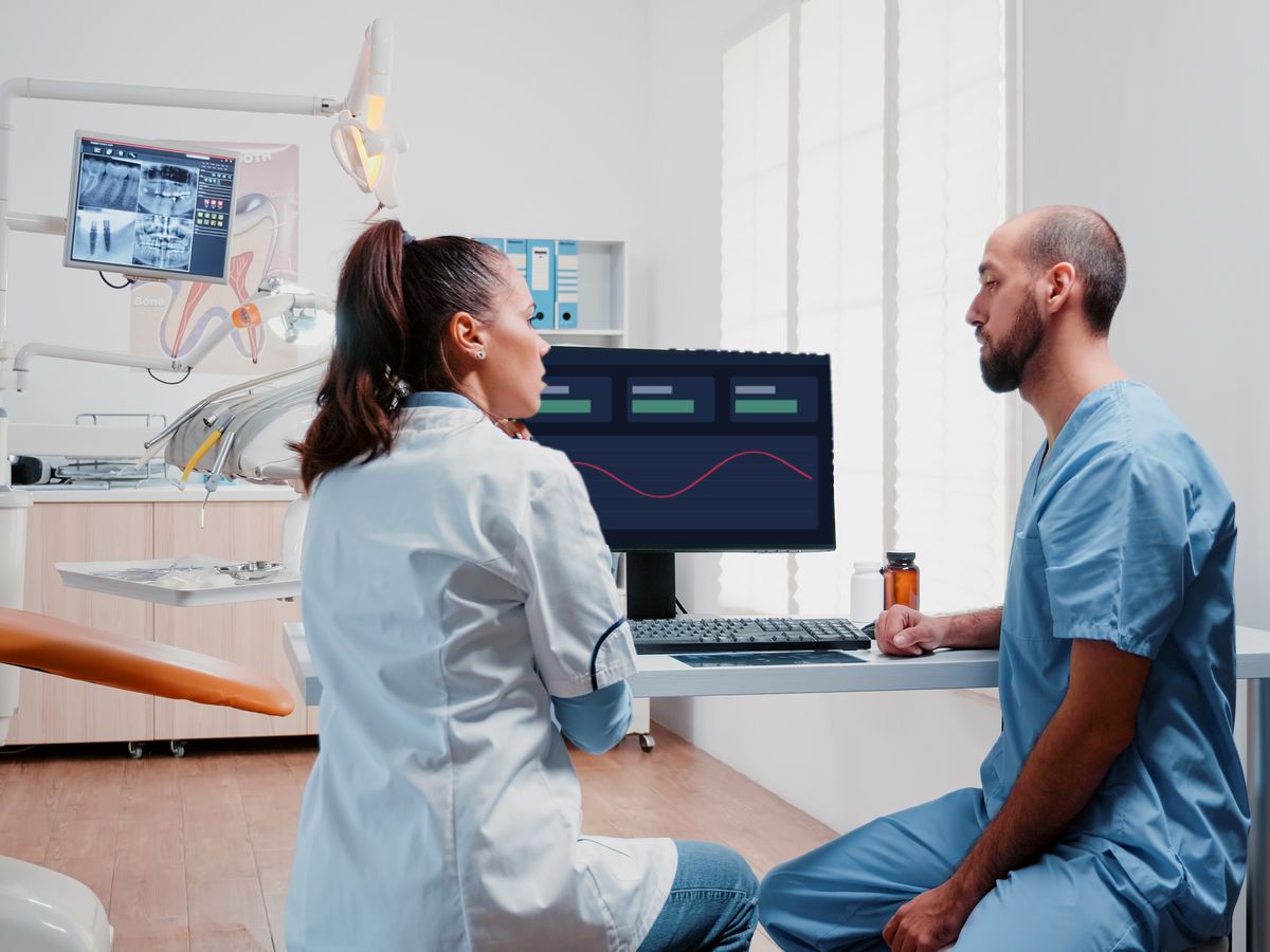 Dental team reviewing a computer in a treatment room